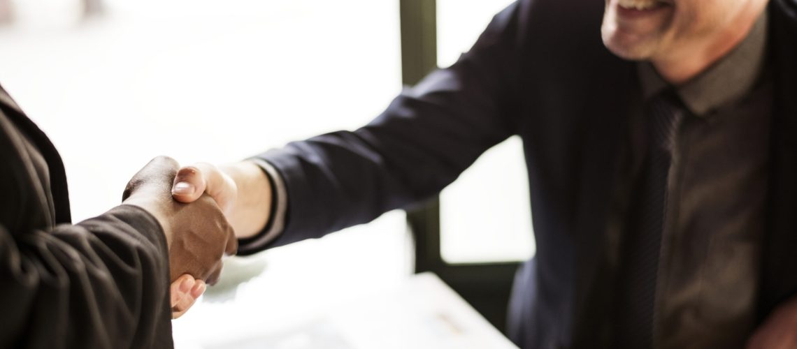 Business partners shaking hands in agreement Business partners shaking hands in agreement